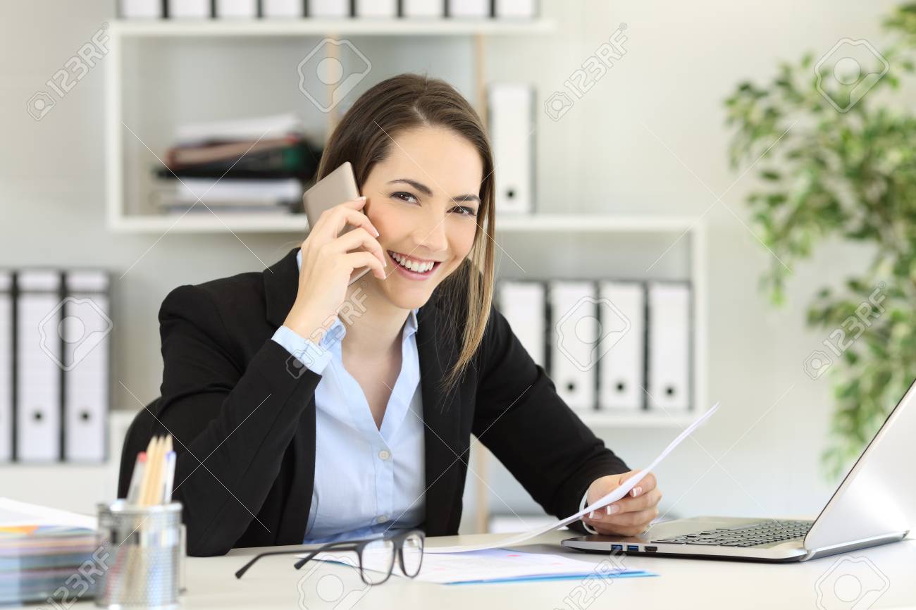 Happy Office Worker Calling On Phone Looking At You At Workplace Stock Photo Picture And Royalty Free Image Image 102076885