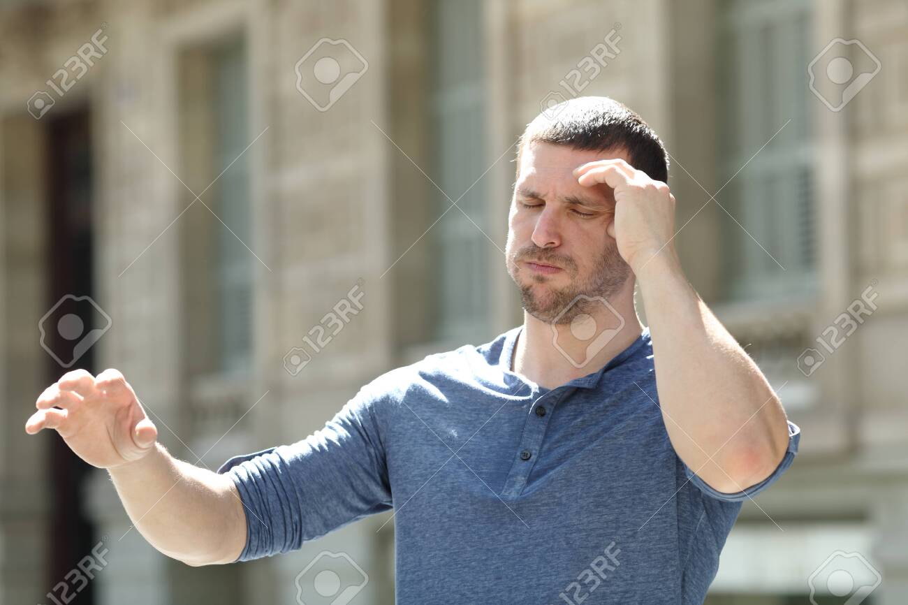 Dizzy adult man suffering headache trying to stay standing in the street - 131834848 Dizzy adult man suffering headache trying to stay standing in the street - 131834848