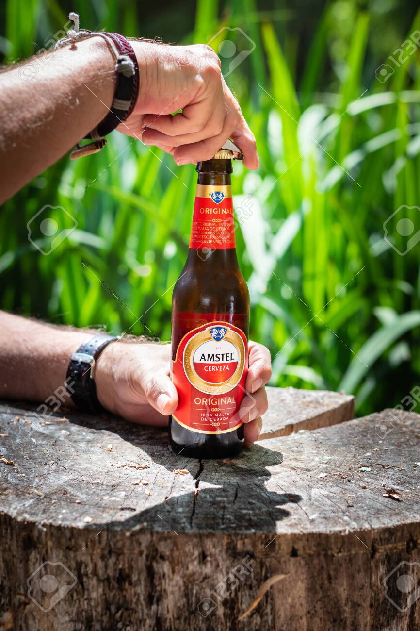 A Man Openning A Amstel Beer Bottle In The Country Stock Photo Picture And Royalty Free Image Image 144455486