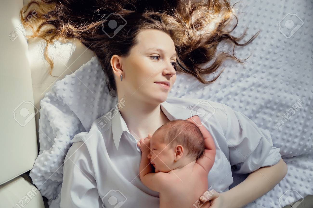 mom sleeping with baby on chest
