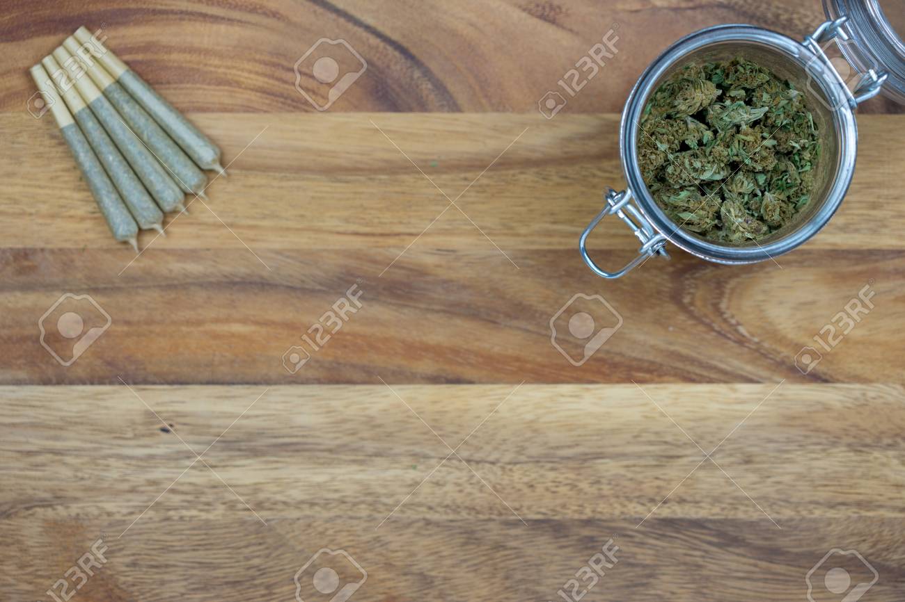 Download Cone Shaped Joints With Weed Nugs In A Glass Jar On A Wood Surface Stock Photo Picture And Royalty Free Image Image 97844262 Yellowimages Mockups