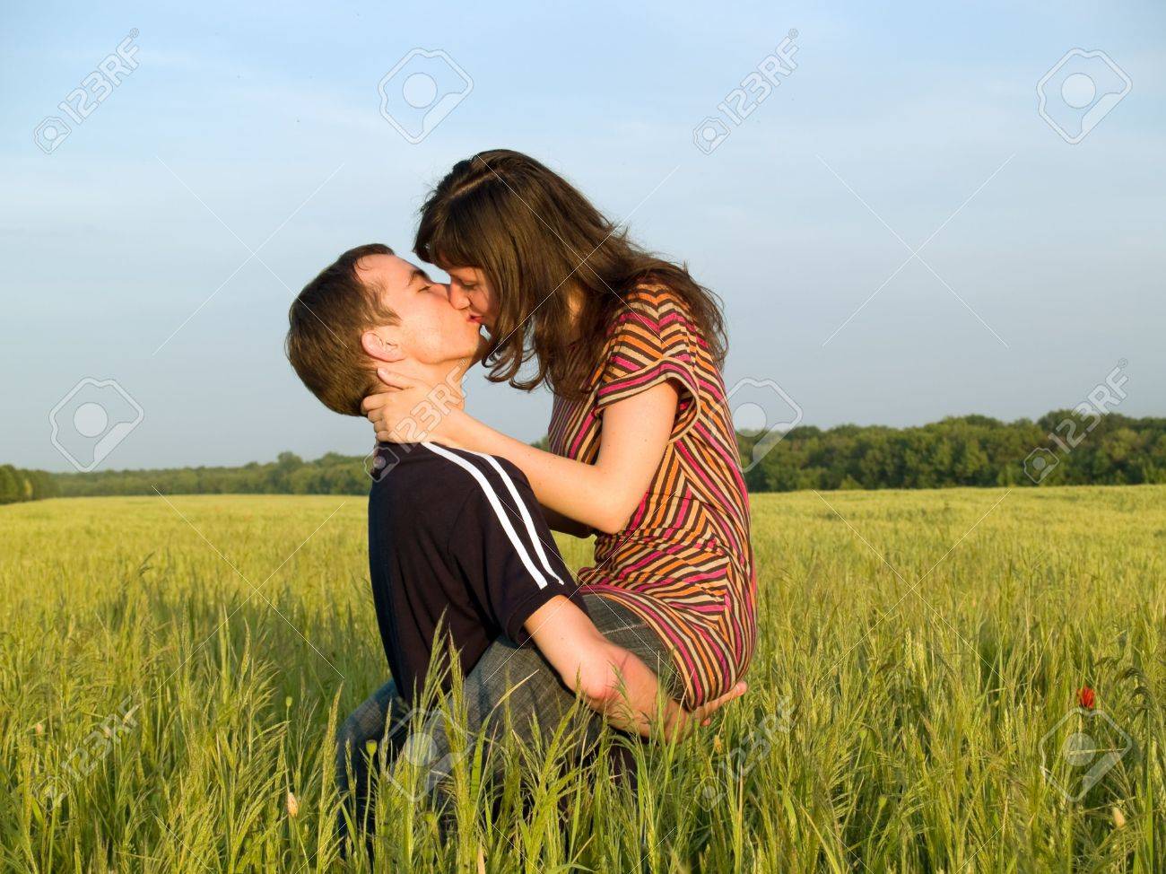 Teen Couple Ing In Field Husband Holds