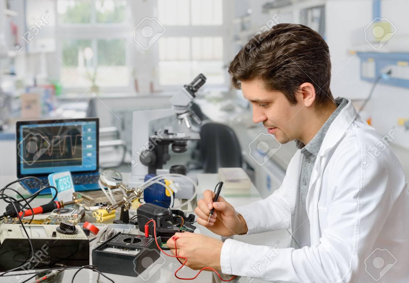 young energetic male tech or engineer repairs electronic equipment tech engineer