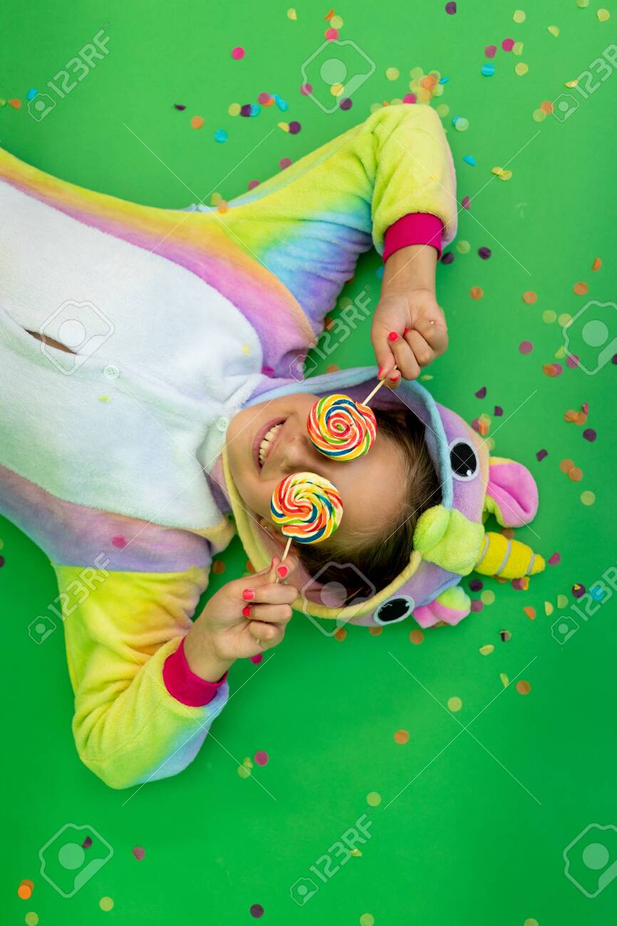 little girls in bright costumes lie on a green isolated background stock photo picture and royalty free image image 152153771 little girls in bright costumes lie on a green isolated background