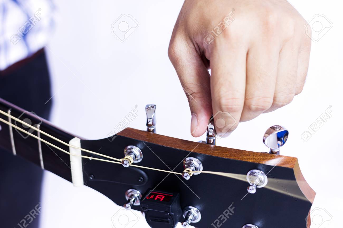 선택적 포커스에서 흰색 배경 위에 기타 튜닝하는 사람 로열티 무료 사진, 그림, 이미지 그리고 스톡포토그래피. Image 66283816
