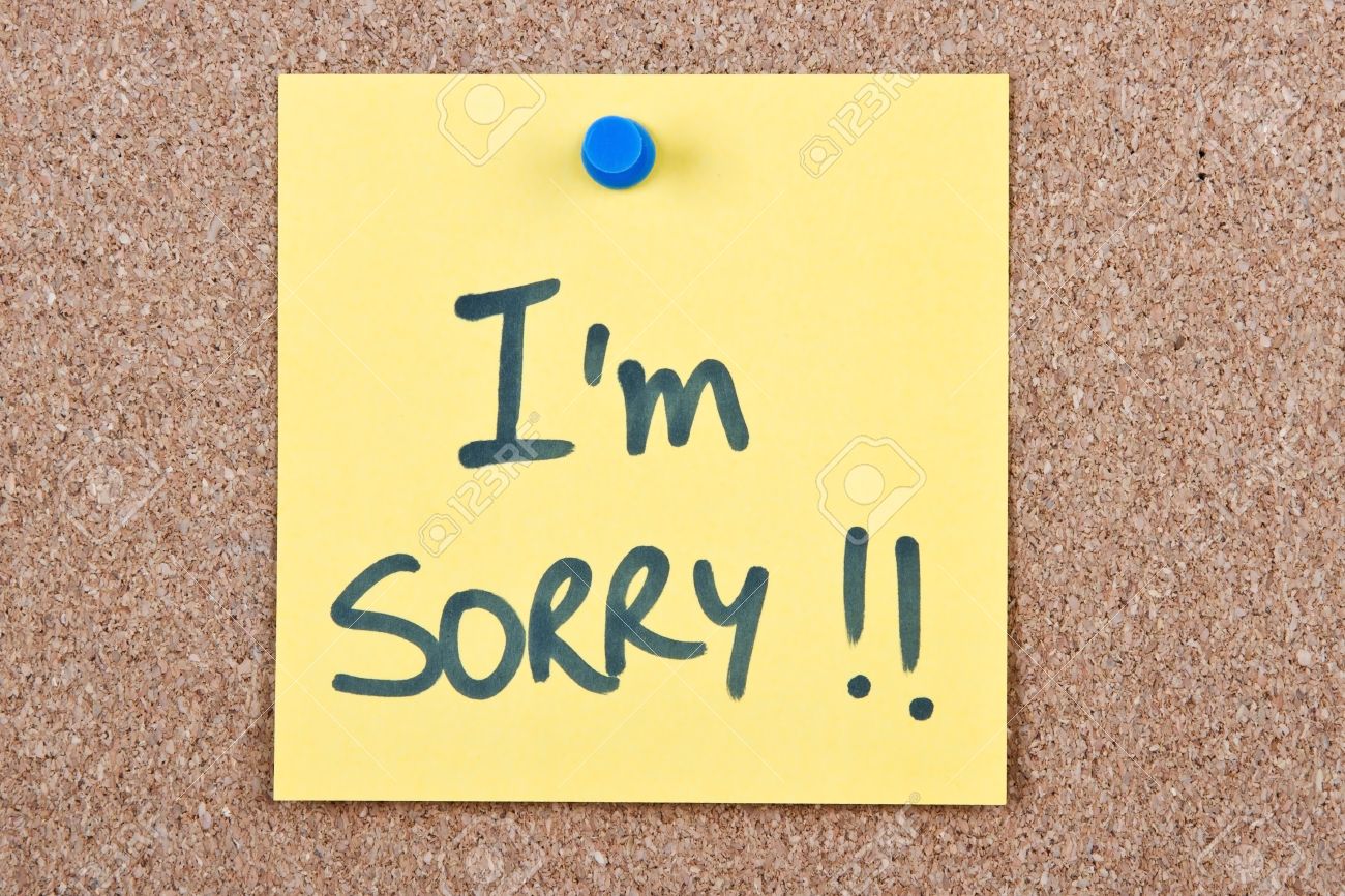 post it note yellow with i m sorry message on cork stock photo