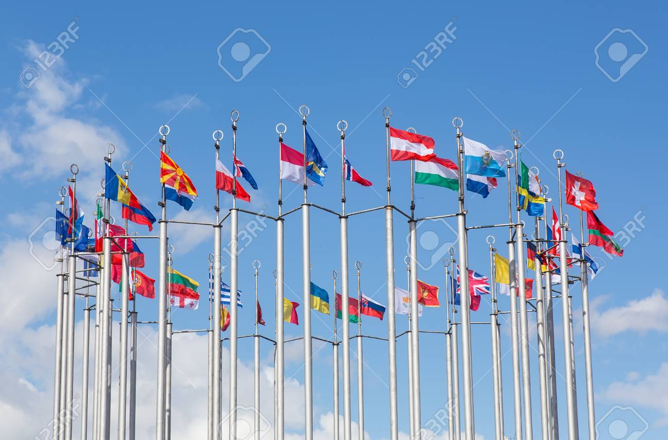 Flags of European states on flagpoles against the background of a cloudy sky. - 102404739 Flags of European states on flagpoles against the background of a cloudy sky. - 102404739