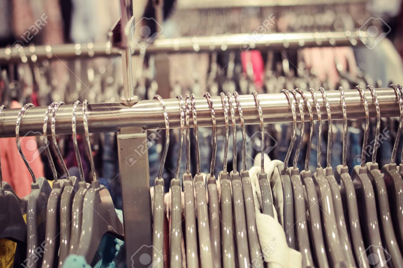 Closeup On Shopping Clothes Hangers On Rail In A Designer Store