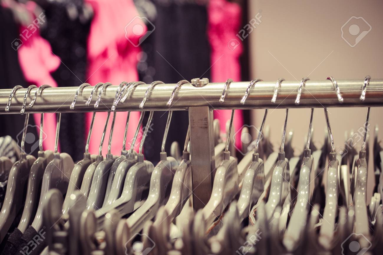 Closeup On Shopping Clothes Hangers On Rail In A Designer Store