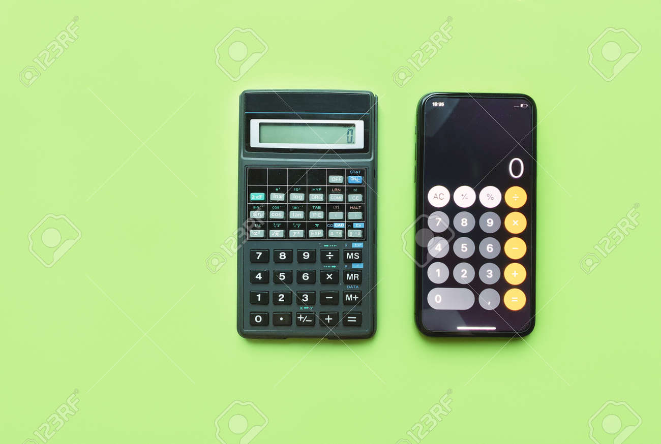Digital calculator and calculator in smartphone on green background. technology development. - 169603135 Digital calculator and calculator in smartphone on green background. technology development. - 169603135