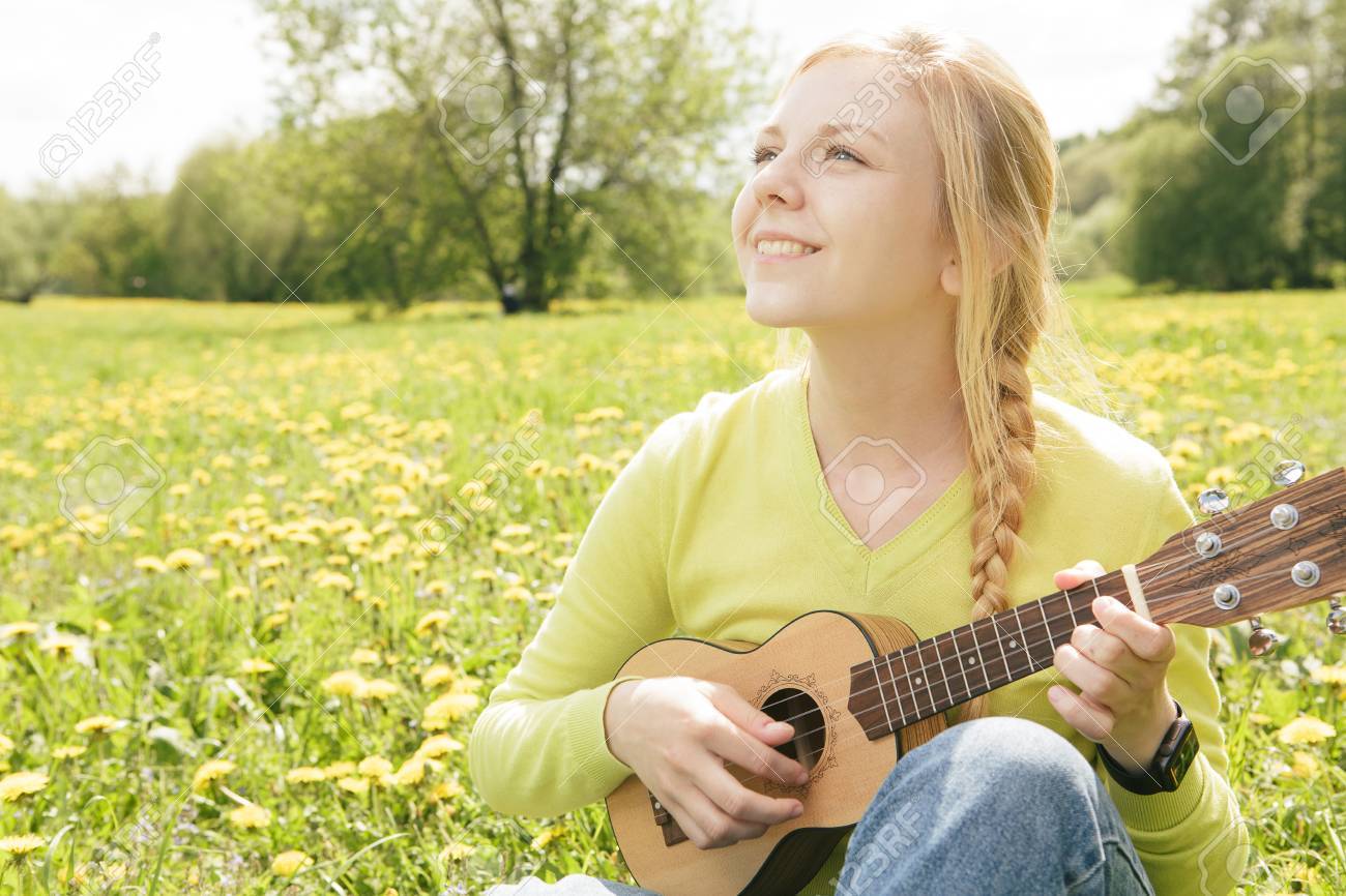 the girl plays a guitar close up stock photo picture and royalty