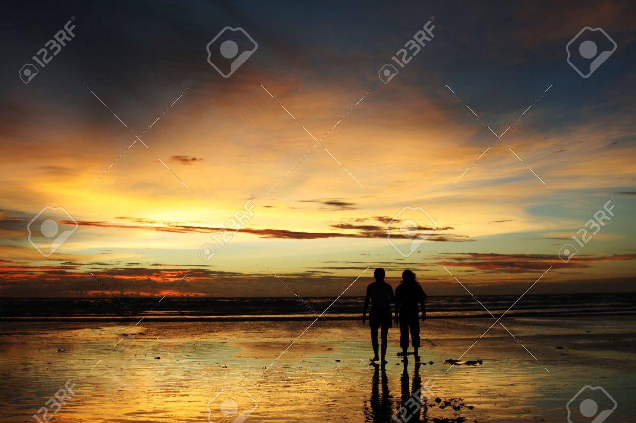Two People In Silhouette Walking On A Beach During Sunset Stock Photo,  Picture and Royalty Free Image. Image 871100., image size:1300x866