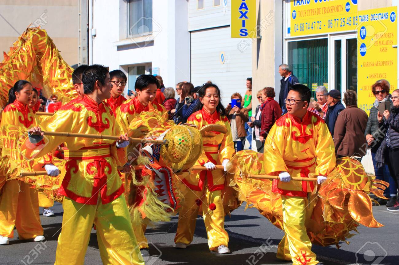 Asian parade with a dragon at the Limoux carnival in Aude, Occitanie in the south of France - 143985301 Asian parade with a dragon at the Limoux carnival in Aude, Occitanie in the south of France - 143985301