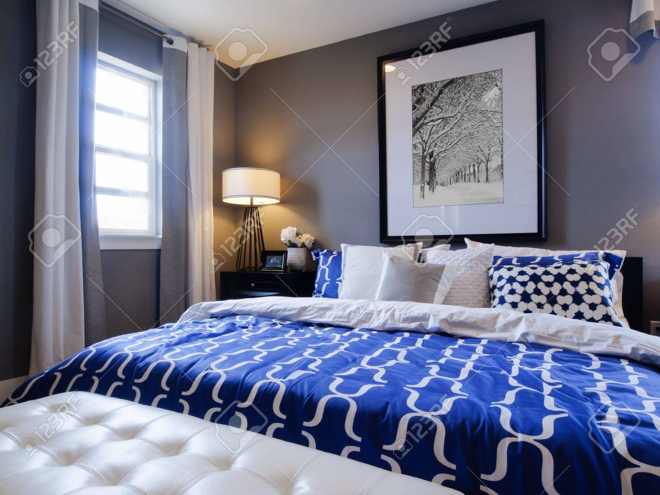 Modern Blue Master Bedroom modern master bedroom with blue wall and white linens. stock photo Modern Blue Master Bedroom modern master bedroom with blue wall and white linens. stock photo