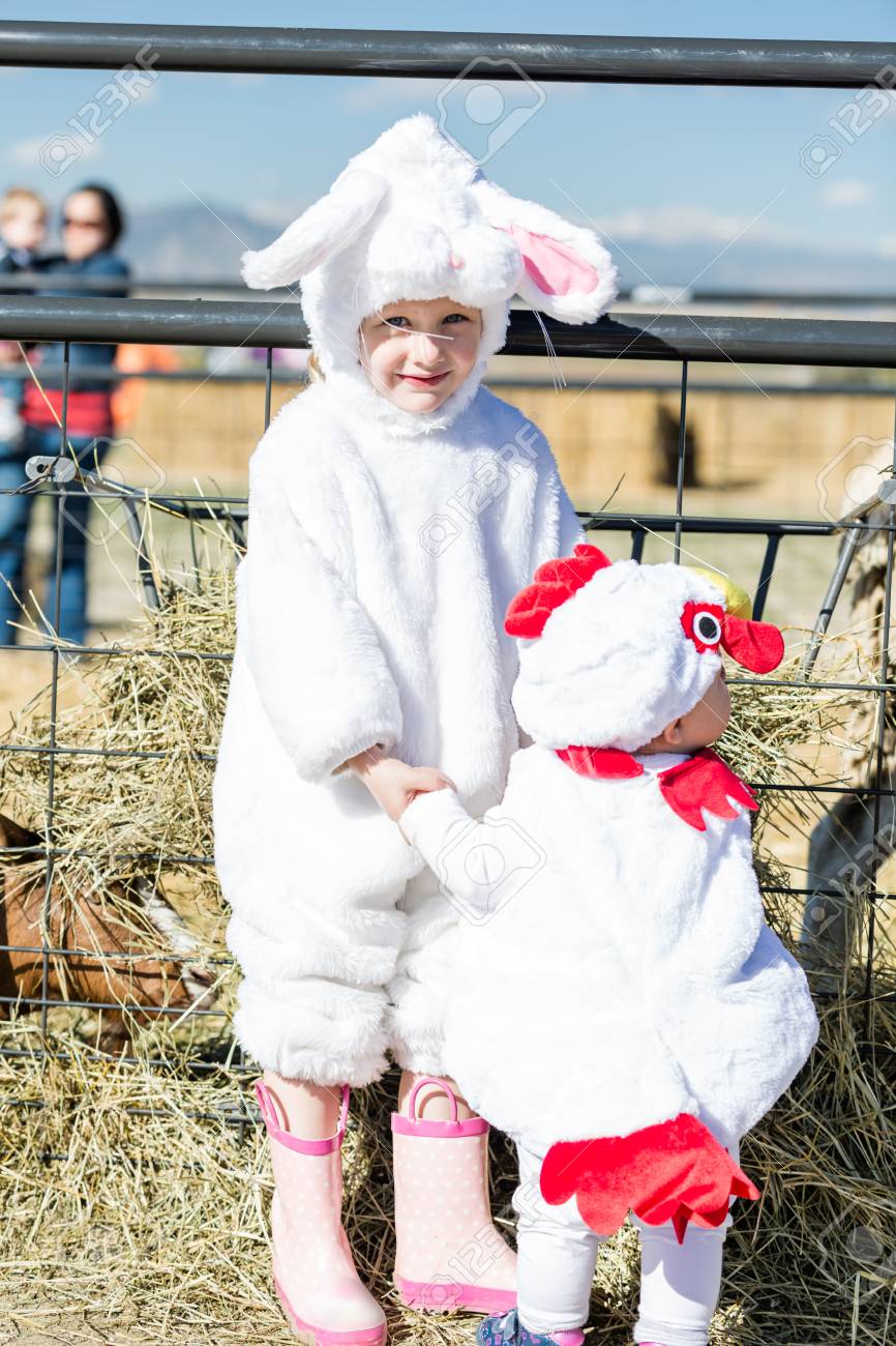 cute kids in halloween costumes at the petting zoo stock photo 32943614