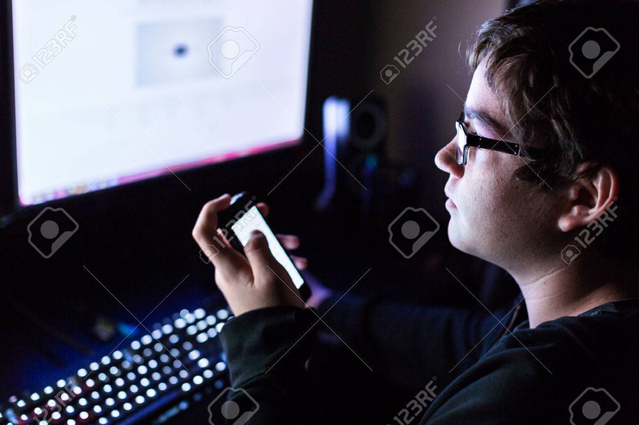Teenager boy on computer in his room late at night. - 39621256 Teenager boy on computer in his room late at night. - 39621256