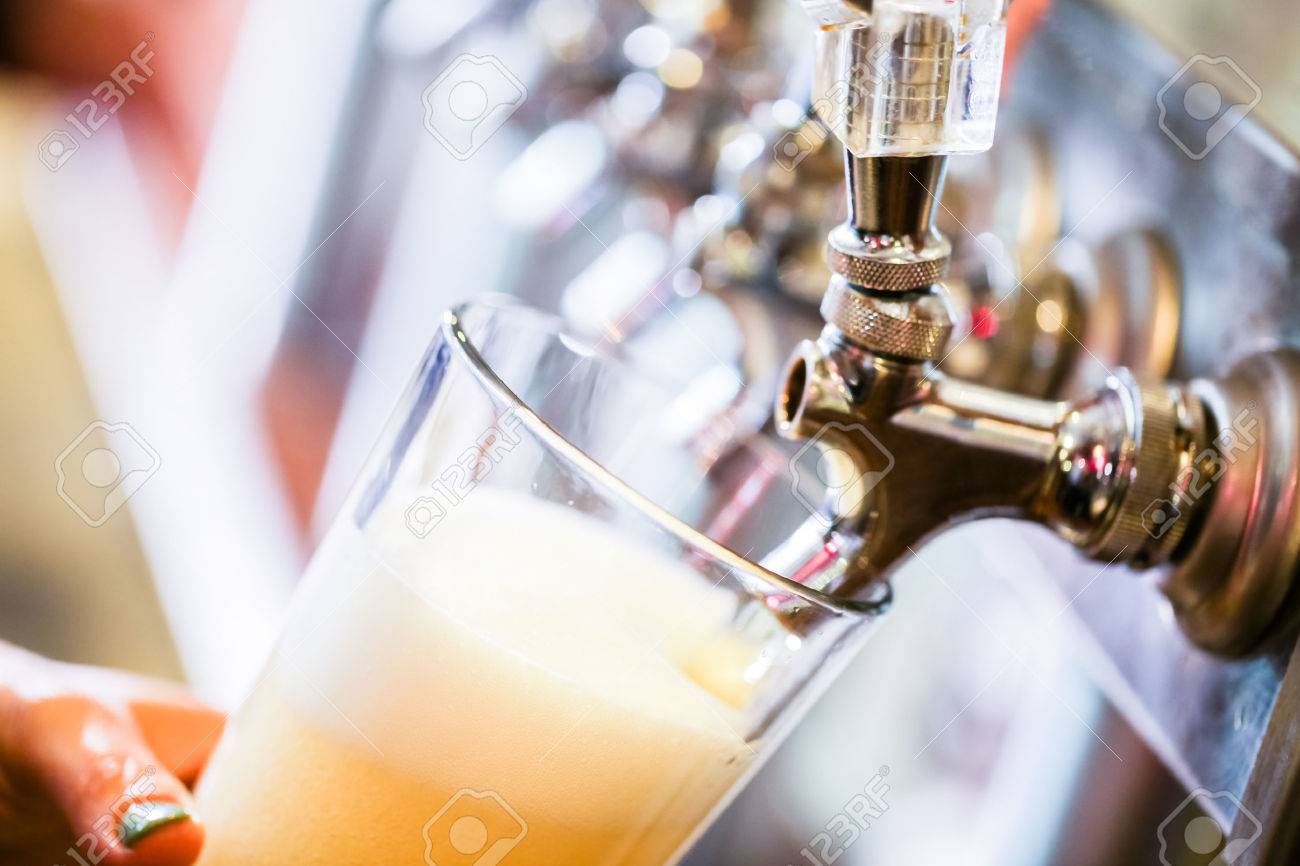 Bartender pouring draft beer in the bar. - 40792789 Bartender pouring draft beer in the bar. - 40792789