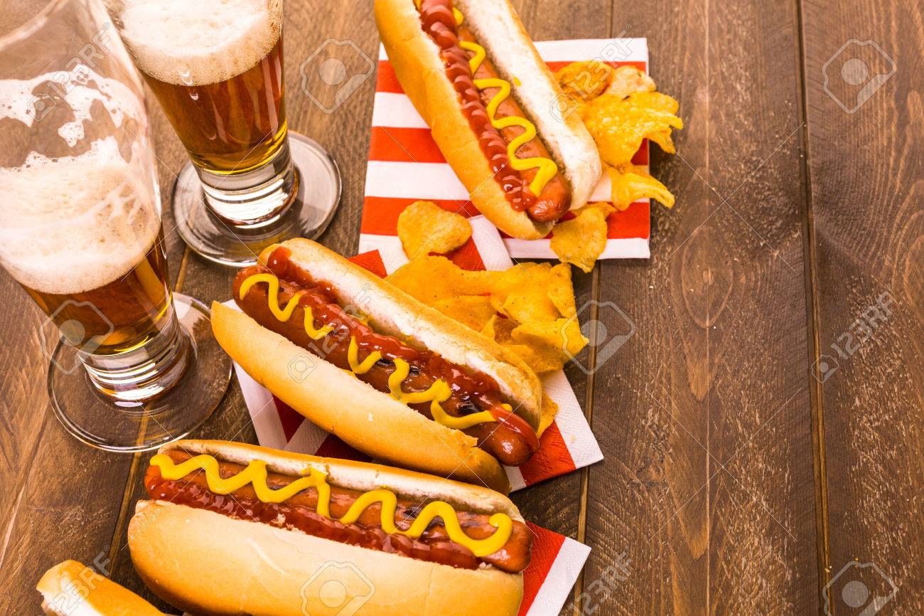Grilled Hot Dogs With Mustard And Ketchup On The Table With Draft ...