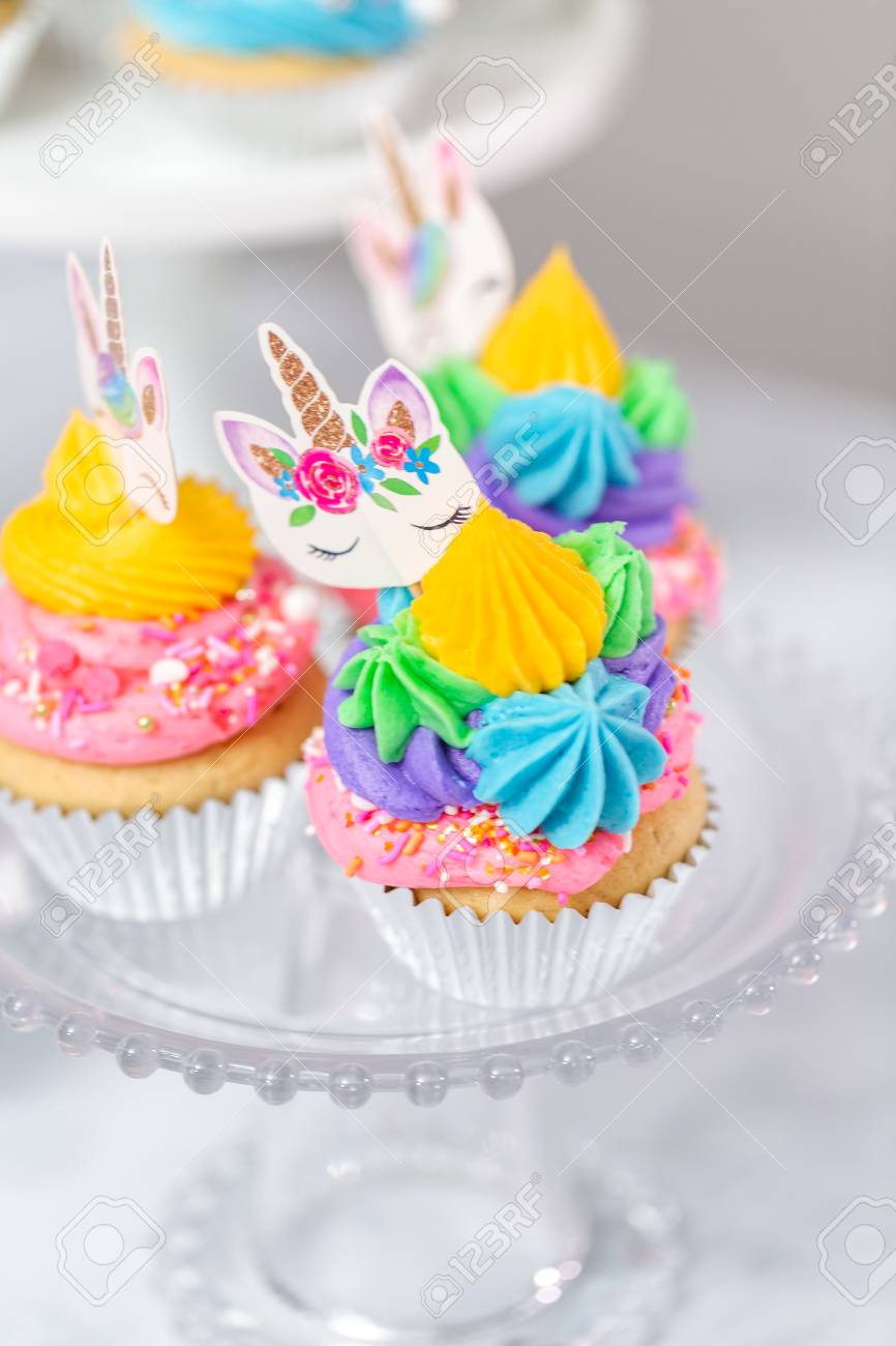 Unicorn Cupcakes With Multicolor Buttercream Icing On Cake Stands