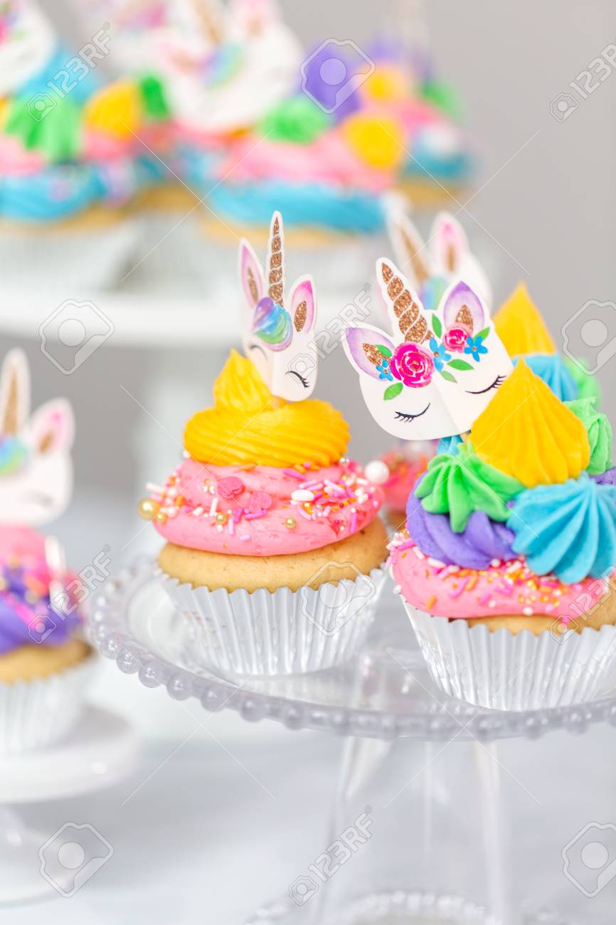 Unicorn Cupcakes With Multicolor Buttercream Icing On Cake Stands