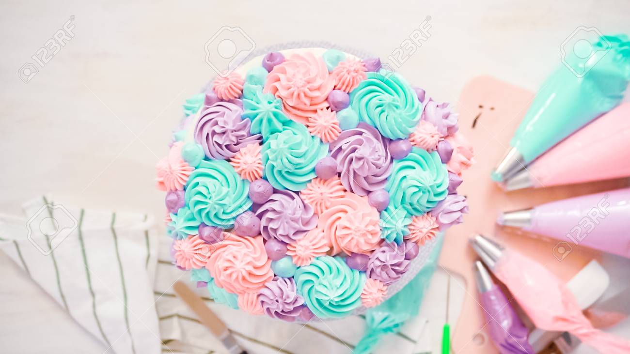 Flat Lay Piping Pastel Color Buttercream Rosettes On A White Cake To Make A Unicorn Cake Stock Photo Picture And Royalty Free Image Image 112466582