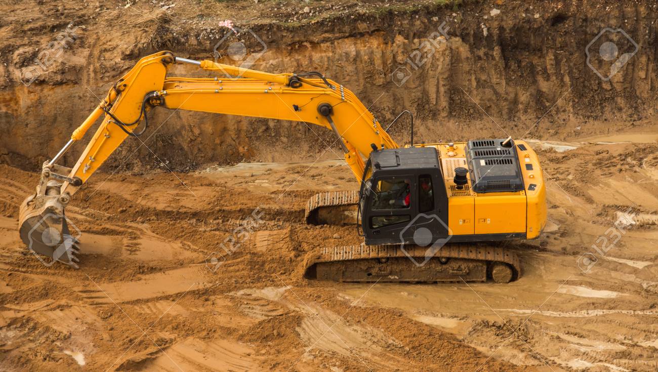 view from above at working excavator tractor digging a trench stock