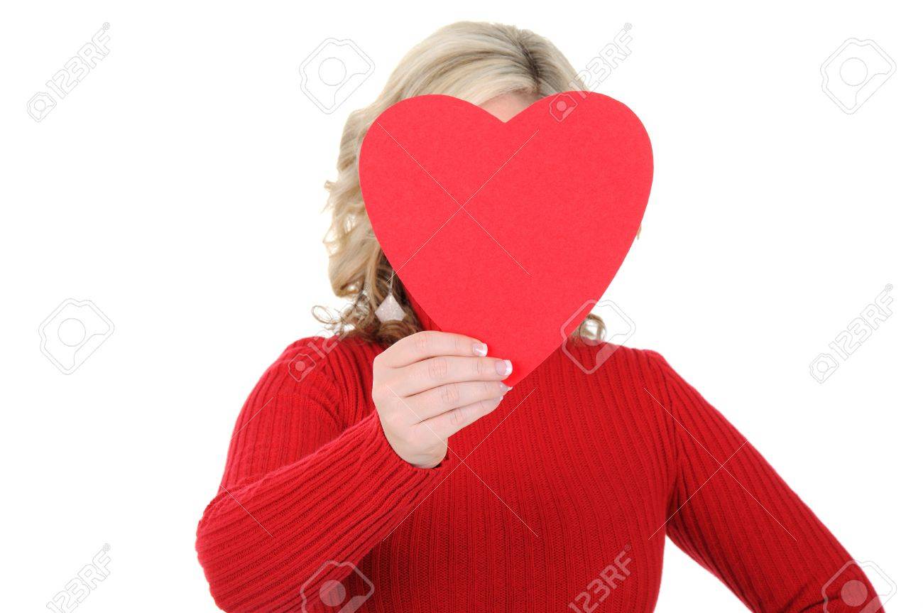 A charming young woman holding a paper heart. Valentine's Day concept. Isolated on a solid white background. - 11889962 A charming young woman holding a paper heart. Valentine's Day concept. Isolated on a solid white background. - 11889962