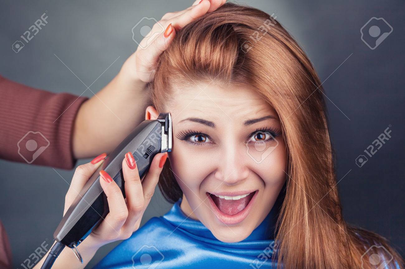 cutting a woman's hair with clippers