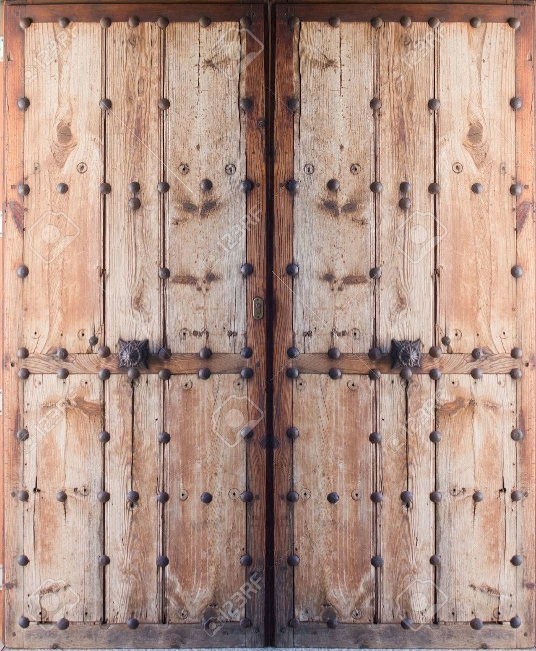 Double Doors Of Antique Wood And Metal Nails, Mallorca, Balearic Double doors of antique wood and metal nails, Mallorca, Balearic islands, Spain. - Double Doors Of Antique Wood And Metal Nails, Mallorca, Balearic