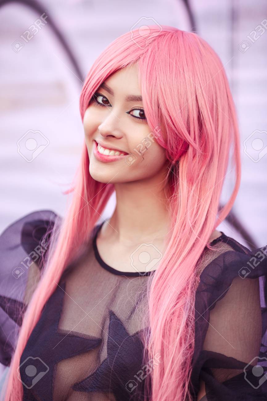 Japan Anime Cosplay. Colorful Close-up Portrait Of Young Attractive Smiling  Asian Woman In Sexy Dress With Creative Make-up Wearing Pink Wig. Trendy  Japanese Girl Walking On City Street. Cool Fashion Look Stock, image size:866x1300