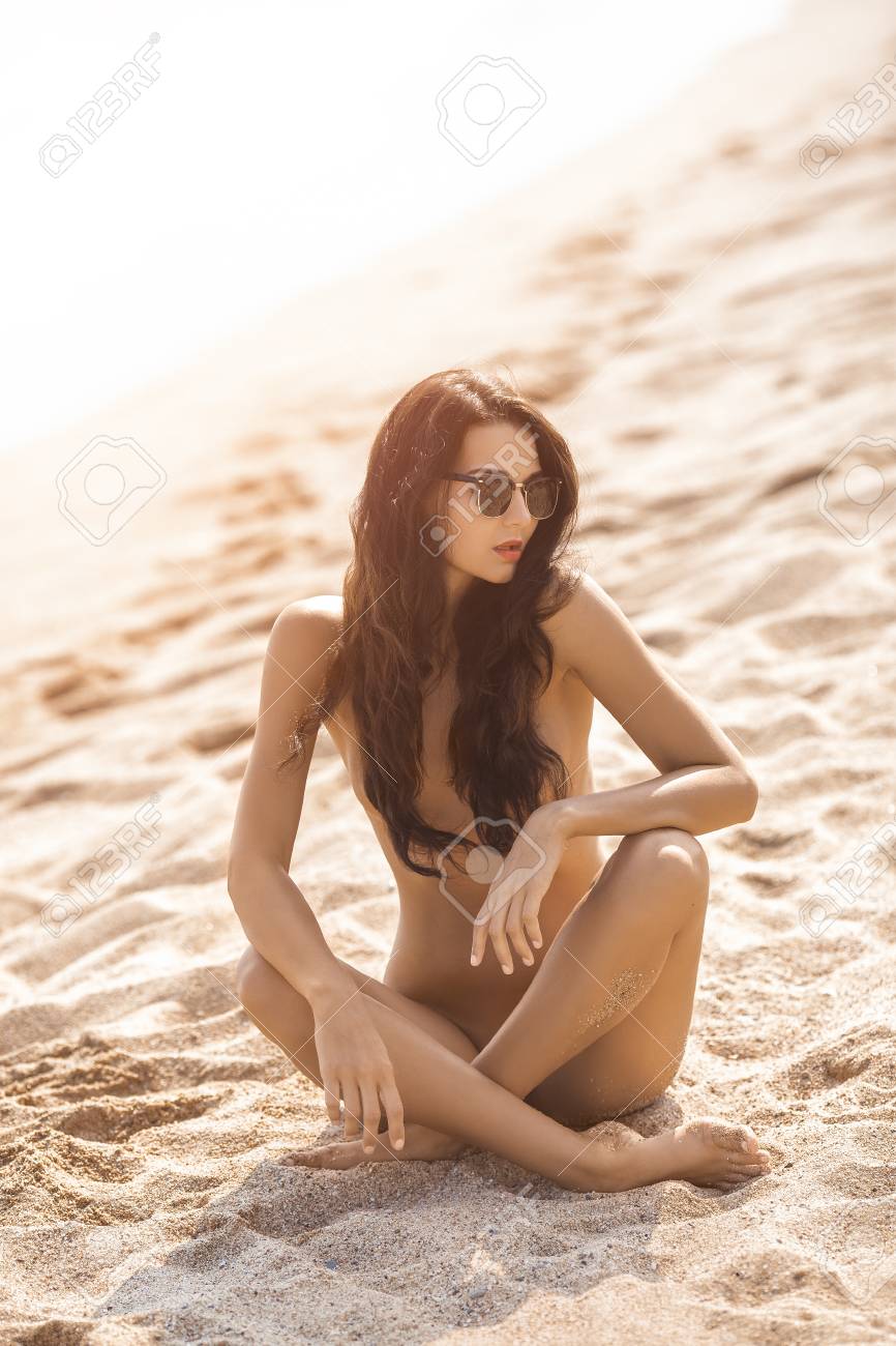 nudism asia Nude Beautiful Woman On The Nudist Beach. Lady With Nude Perfect Body  Sitting On Sand Near Sea. Gorgeous Mixed Race Caucasian Asian Girl Posing  In Sunglasses On Travel Vacation Holidays Naked Outdoors