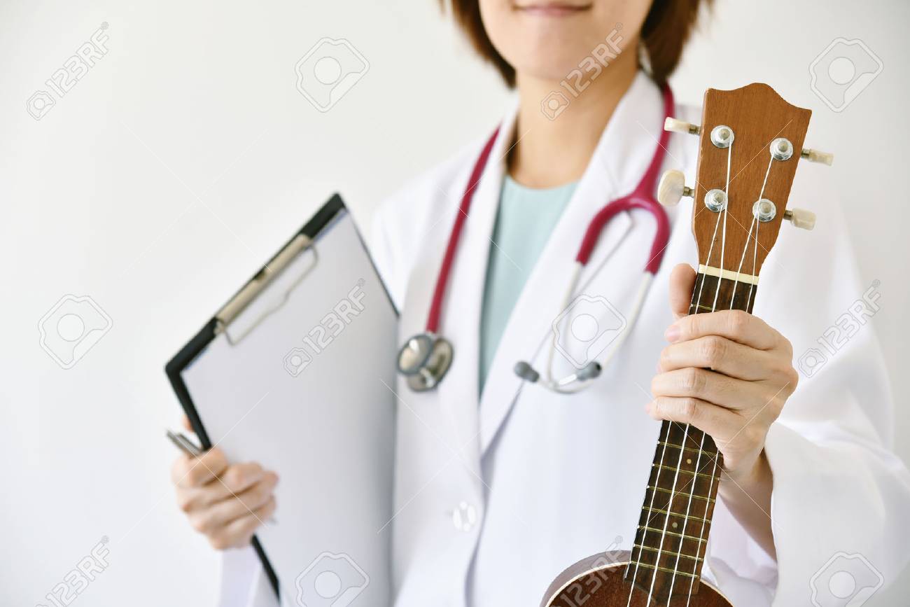 Doctor hand holding ukulele (musical instrument), Music therapy concept. (Selective Focus) - 78354388 Doctor hand holding ukulele (musical instrument), Music therapy concept. (Selective Focus) - 78354388