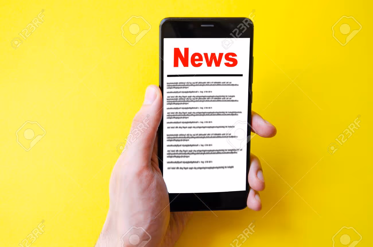 News. Reading the news. The inscription red news on the smartphone screen lies on a yellow background. Male hand holds a smartphone, clicks, leafs through the news - 150685336 News. Reading the news. The inscription red news on the smartphone screen lies on a yellow background. Male hand holds a smartphone, clicks, leafs through the news - 150685336