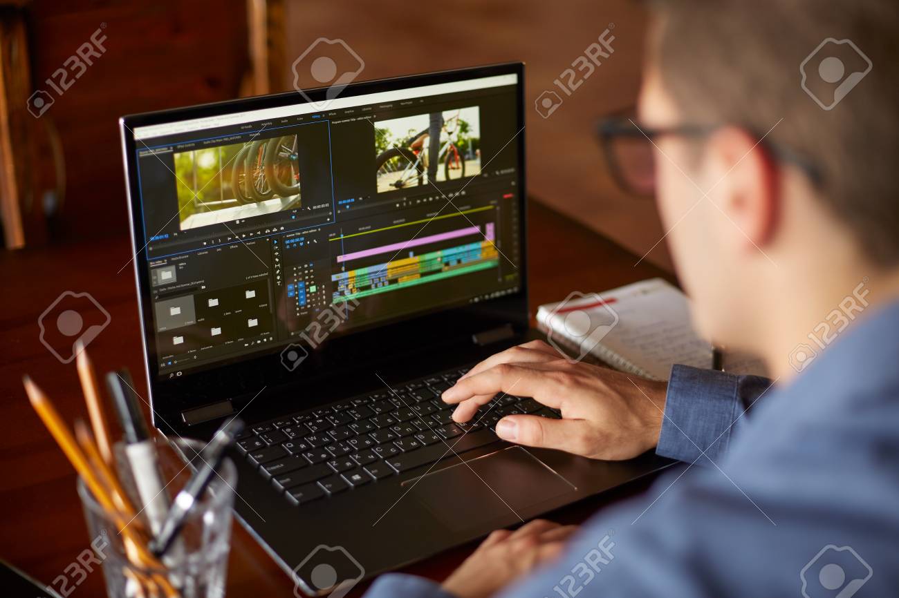 freelancer video editor works at the laptop computer with movie freelancer video