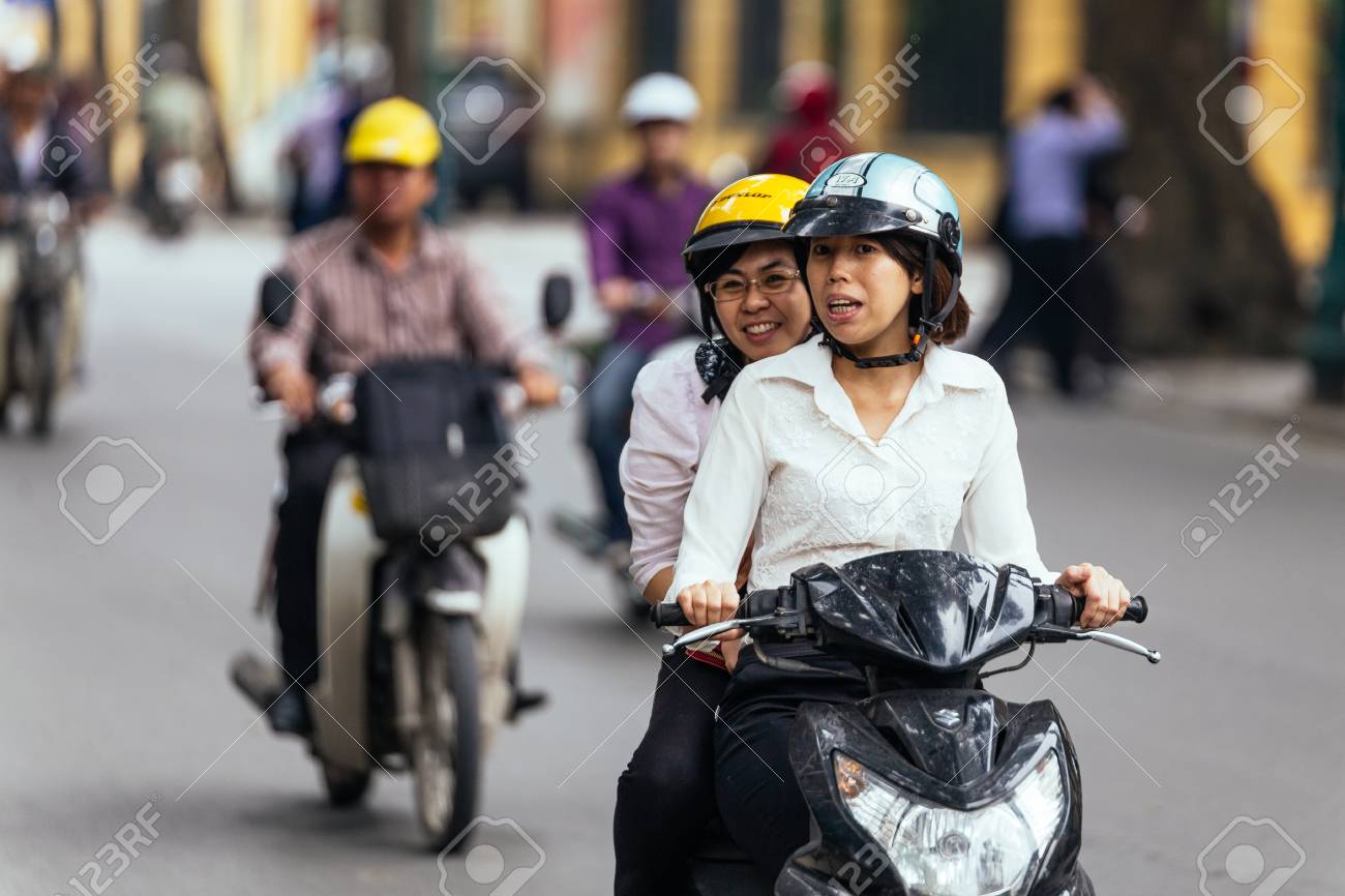 girl riding on back of motorcycle