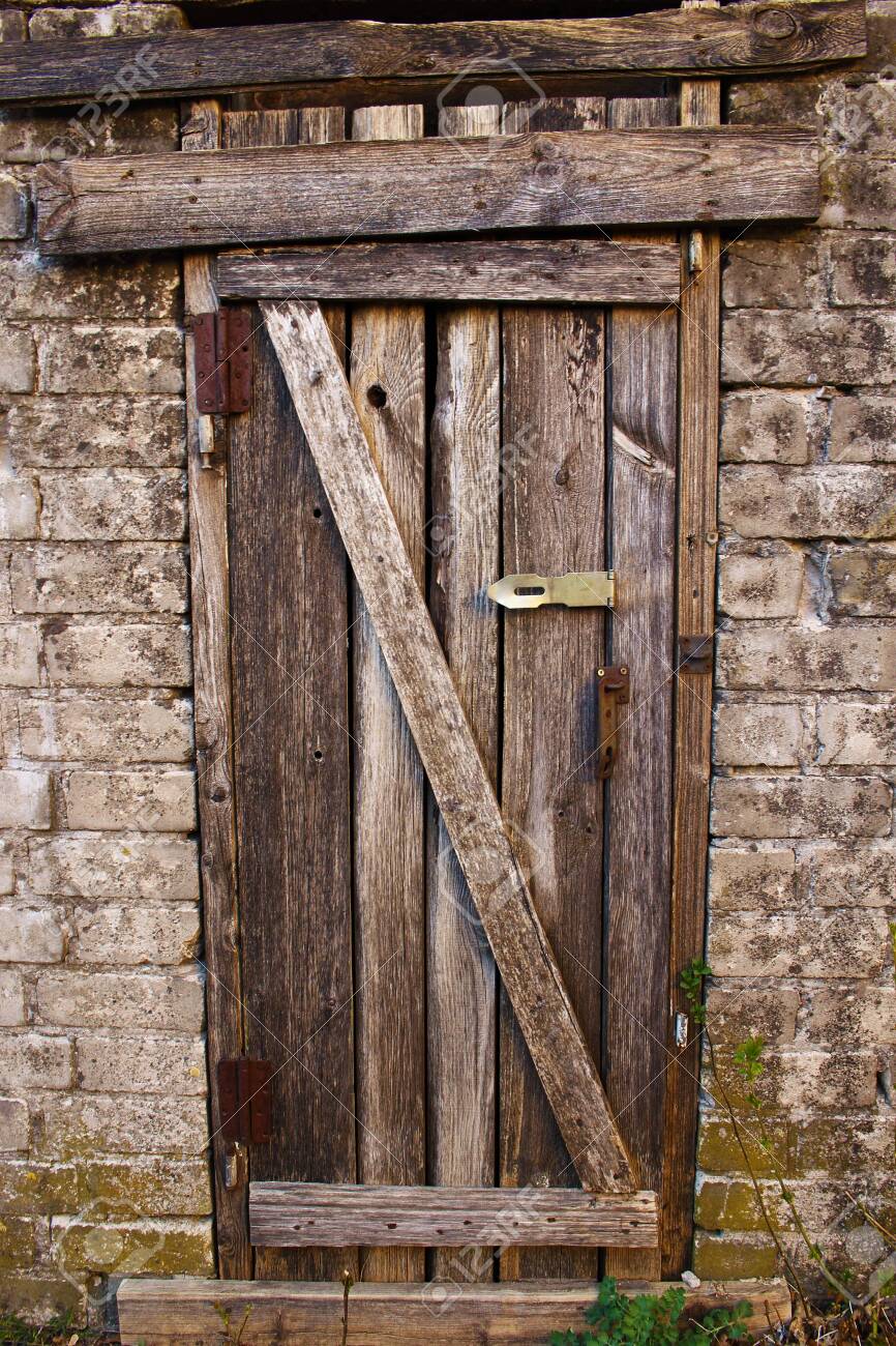 Unlocked Aged Halloween Creepy Wooden Door In Brick Wall Stock Photo Picture And Royalty Free Image Image 130099943