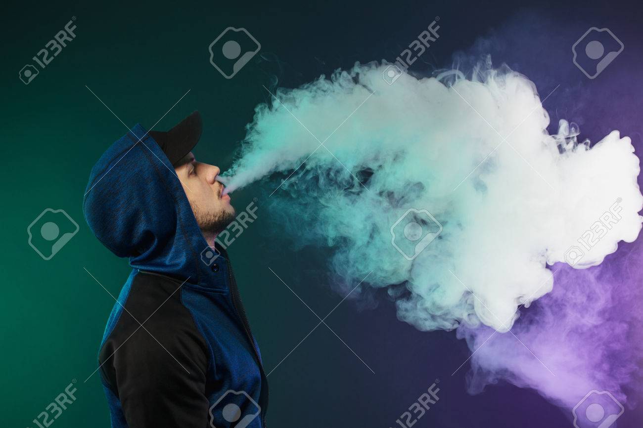 vaping man a cloud of vapor dark blue background stock photo dark vapor