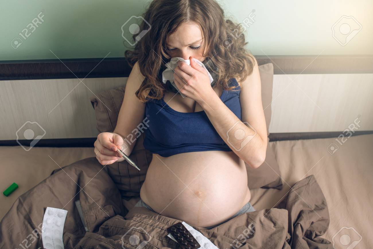 Young Pregnant Woman In Bed With Pills And A Thermometer Sick Stock Photo Picture And Royalty Free Image Image 88151654