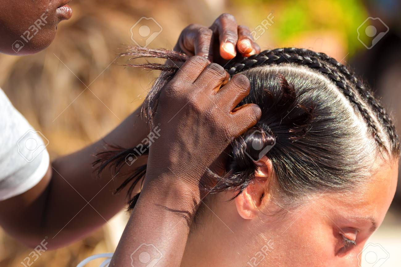 Black Woman Weaves Traditional Afro Hairstyle On White Women