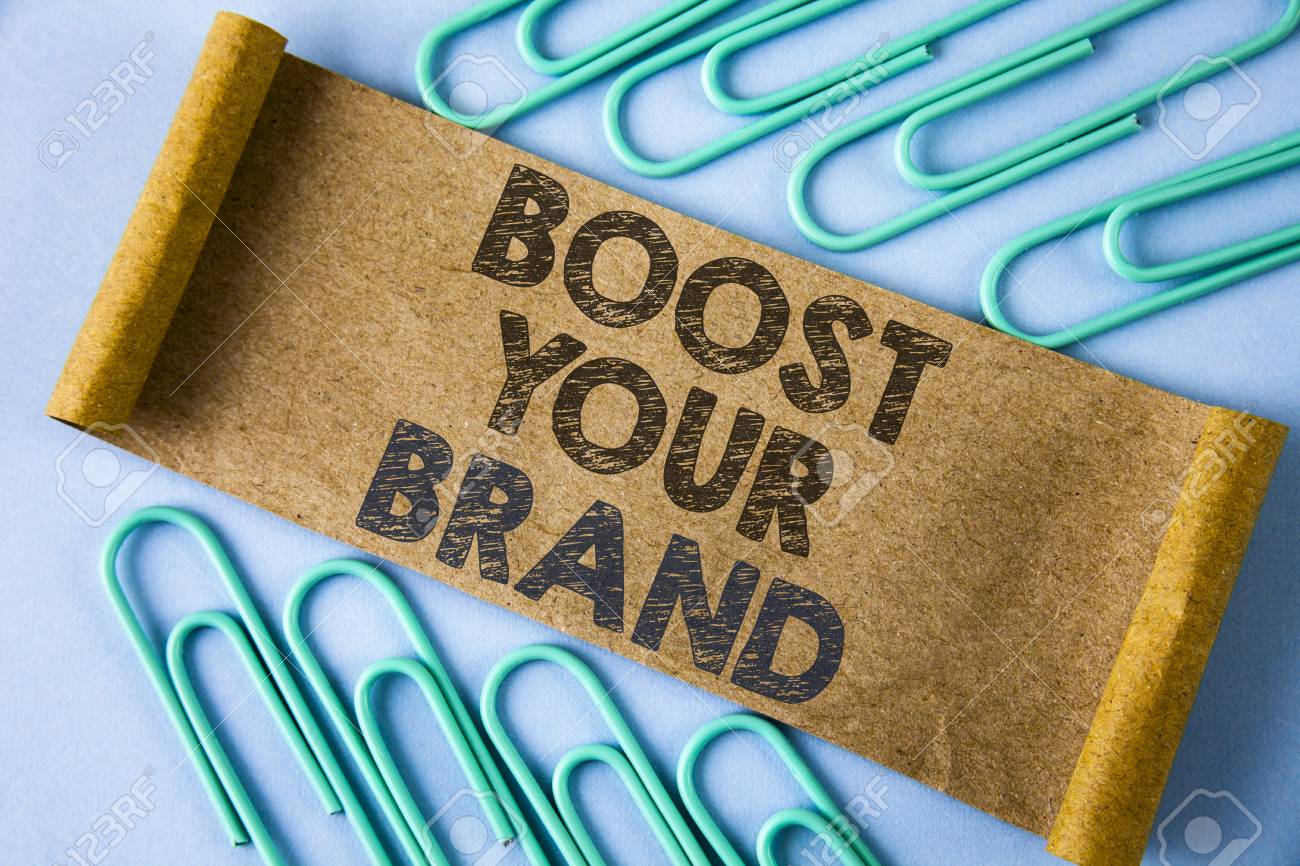 Text Sign Showing Boost Your Brand. Conceptual Photo Improve Your Models Name In Your Field Overcome Competitors Written Folded Cardboard Paper Piece Plain Blue Background Within Paper Pins. Stock Photo, Picture And