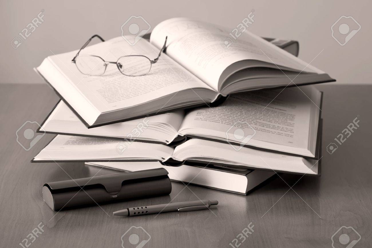 opened books pen and glasses on sepia background - 8512575 opened books pen and glasses on sepia background - 8512575