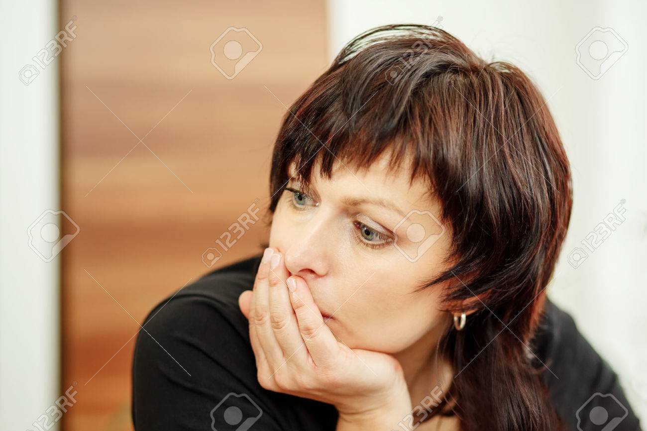 beautiful middle age tired woman holding head, looking out - 28790470 beautiful middle age tired woman holding head, looking out - 28790470