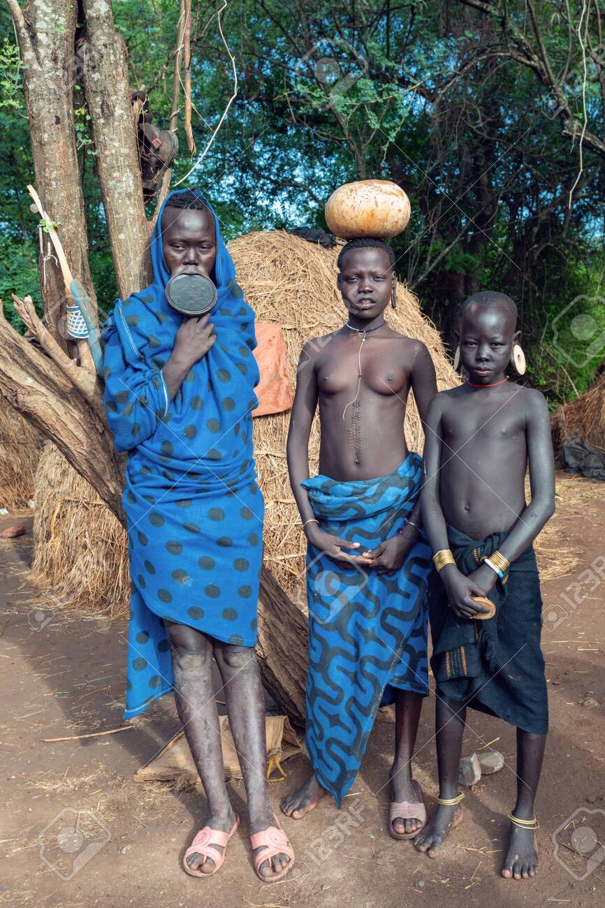 african tribe child ETHIOPIA, OMO VALLEY, MAY 6: Group of women and children of wildest and  most dangerous African Mursi people tribe living according to original  traditions in Omo valley, May 6, 2018, Ethiopia, Africa