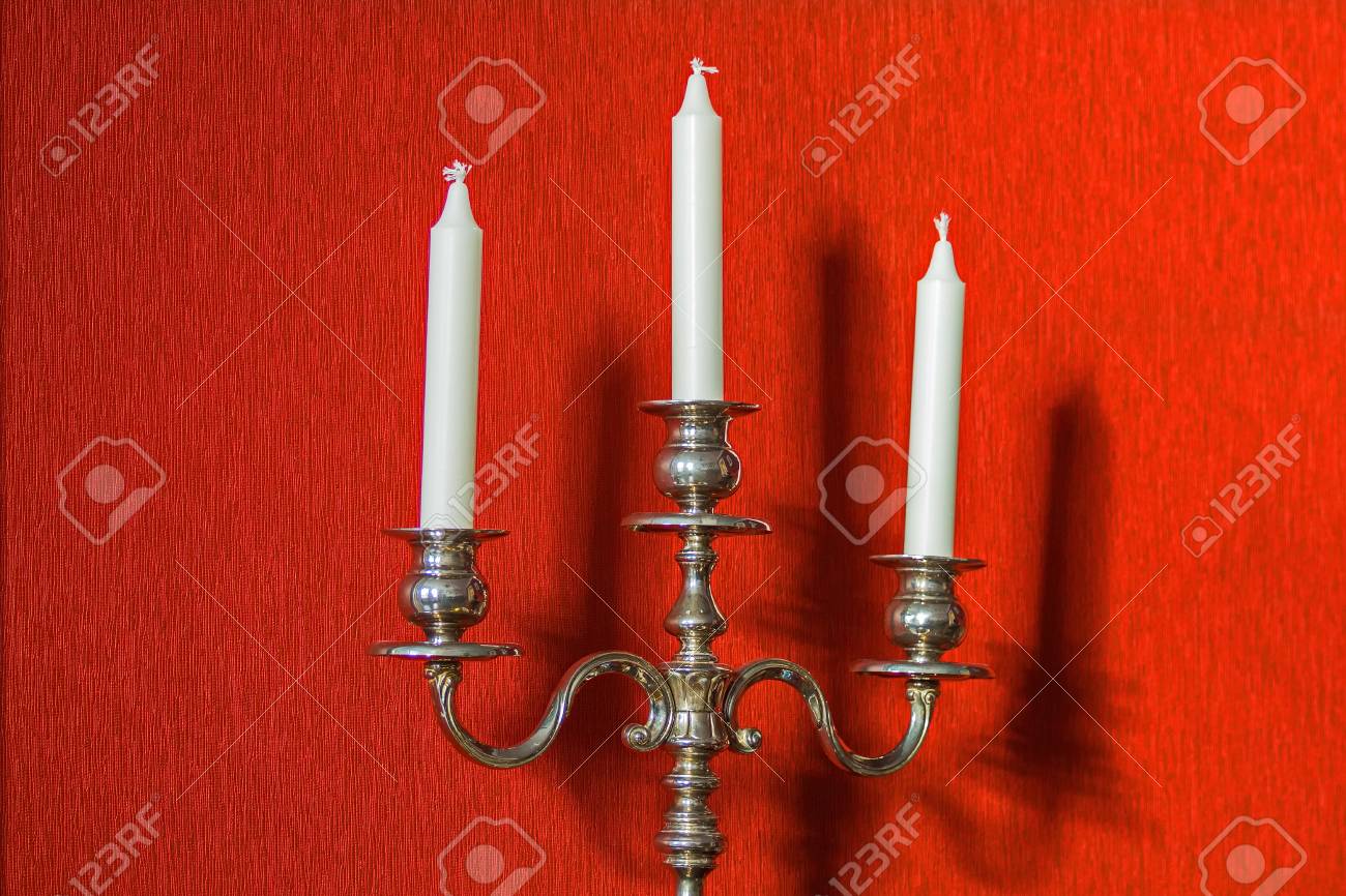 An old candlestick and its shadow on the wall. Under the sun. - 118778542 An old candlestick and its shadow on the wall. Under the sun. - 118778542