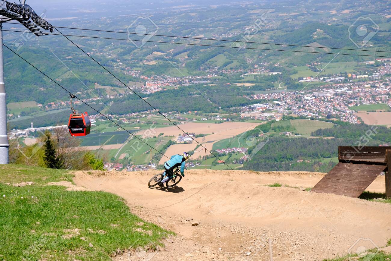 Maribor, Slovenia - May 2, 2019: Downhill mountain bikers riding down the trail on Pohorje near Maribor, Slovenia. Pohorje bike park is very popular with riders. - 137010541 Maribor, Slovenia - May 2, 2019: Downhill mountain bikers riding down the trail on Pohorje near Maribor, Slovenia. Pohorje bike park is very popular with riders. - 137010541