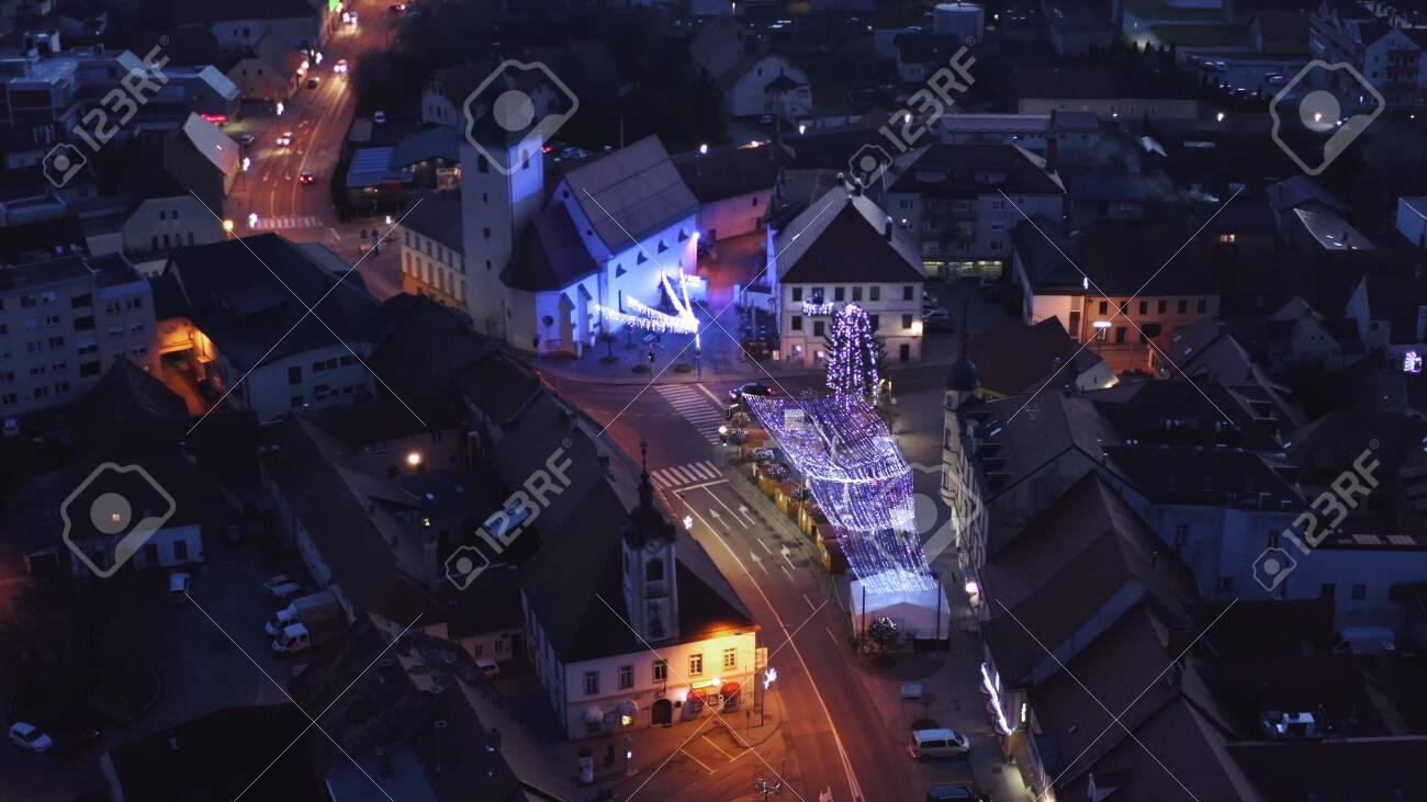 Slovenska Bistrica, Slovenia - Dec 25 2019: Aerial view of Christmas fair on main square in Slovenska Bistrica, a small medieval town in Slovenia, cars pass by on main street - 137012208 Slovenska Bistrica, Slovenia - Dec 25 2019: Aerial view of Christmas fair on main square in Slovenska Bistrica, a small medieval town in Slovenia, cars pass by on main street - 137012208