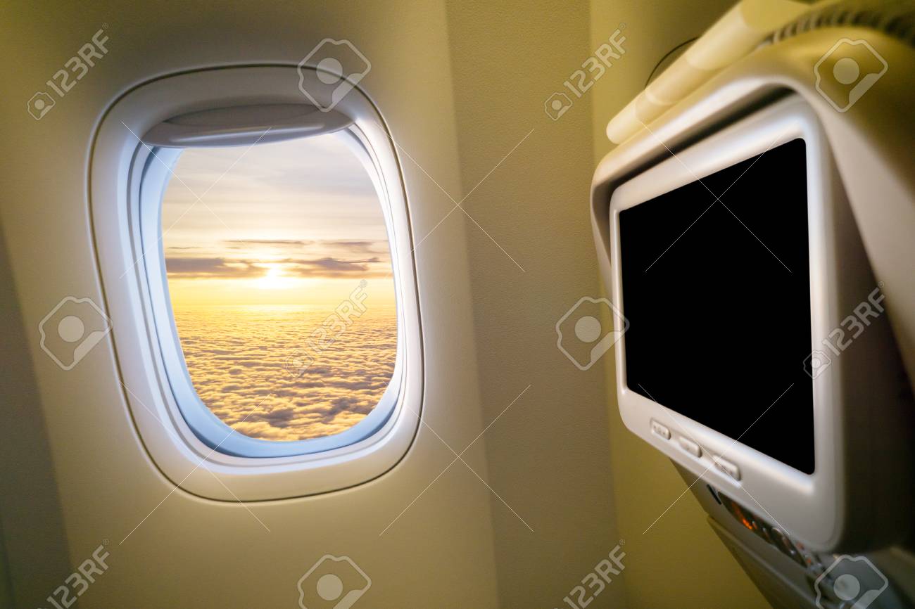 clouds and sky as seen through window of an aircraft plane interior