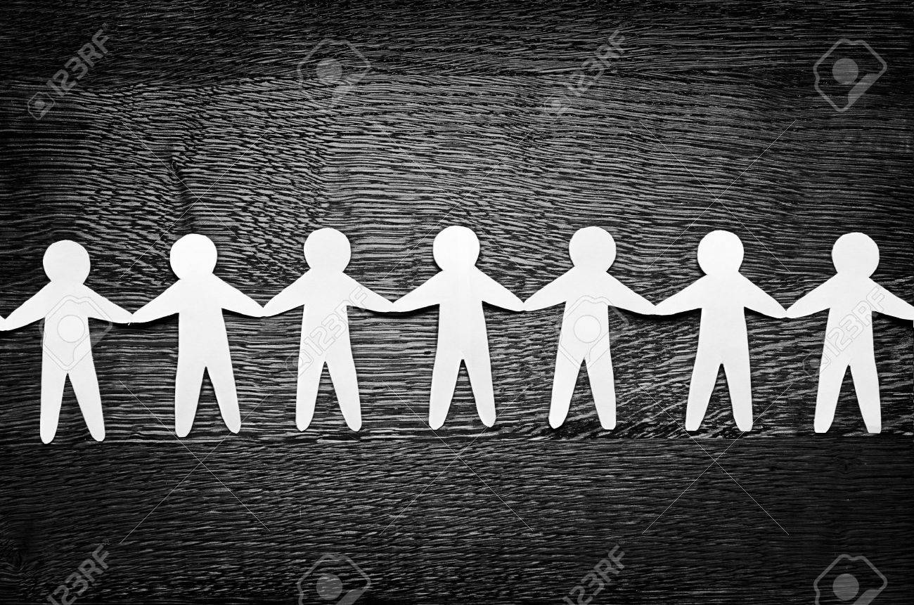 Cutout paper people on wooden table and artistic shadows added - 13023773 Cutout paper people on wooden table and artistic shadows added - 13023773