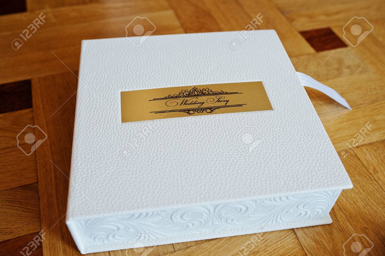 white leather wedding book or wedding album on wooden background white wedding album