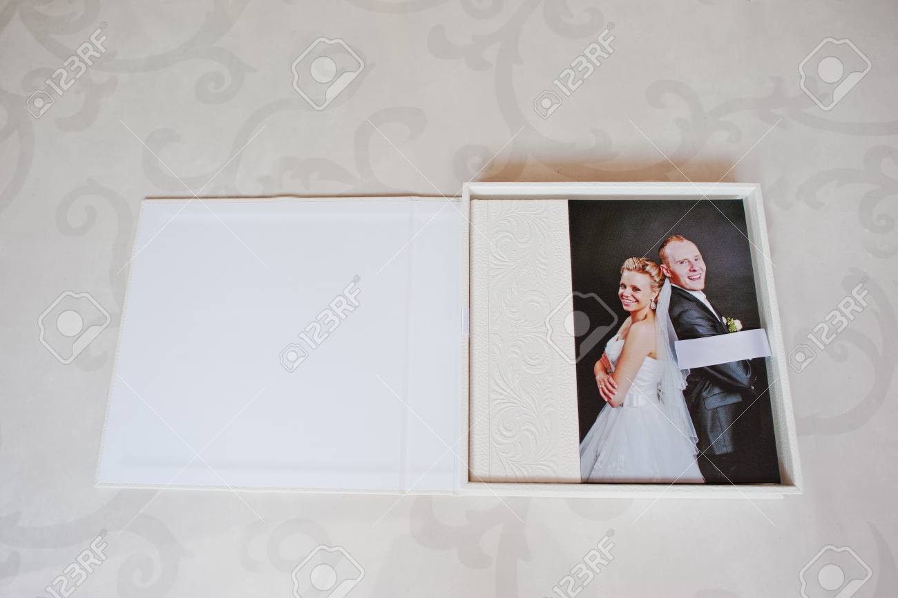 white leather wedding album with photo on canvas of newlyweds white wedding photo album
